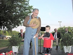 Grandpa and child honor fallen soldiers.